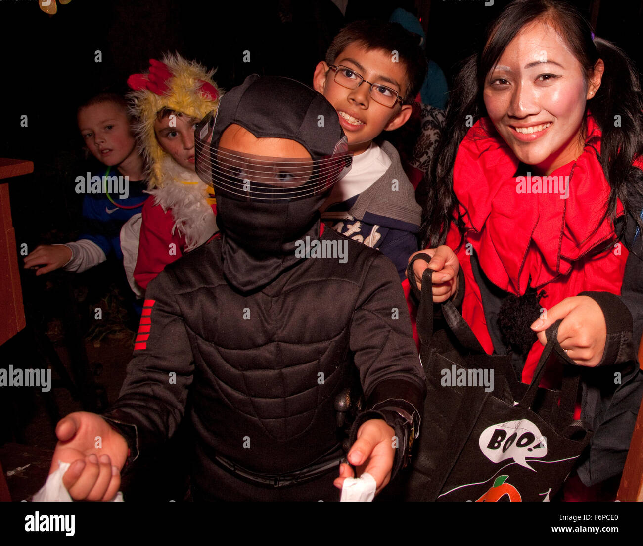 Asian and white Americans teen and children costumed Halloween trick or