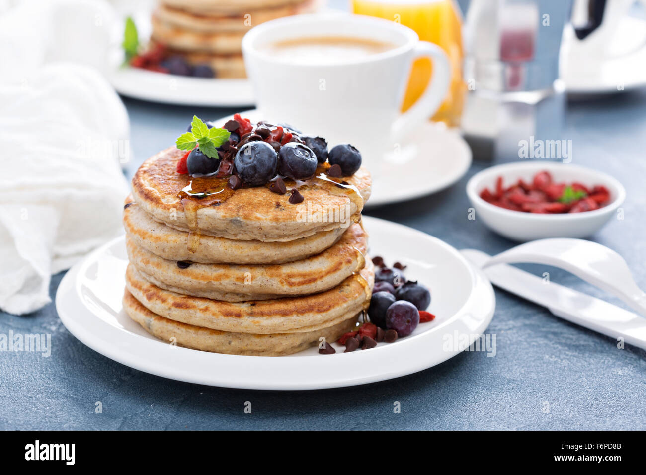 Fluffy chocolate chip pancakes on breakfast table Stock Photo