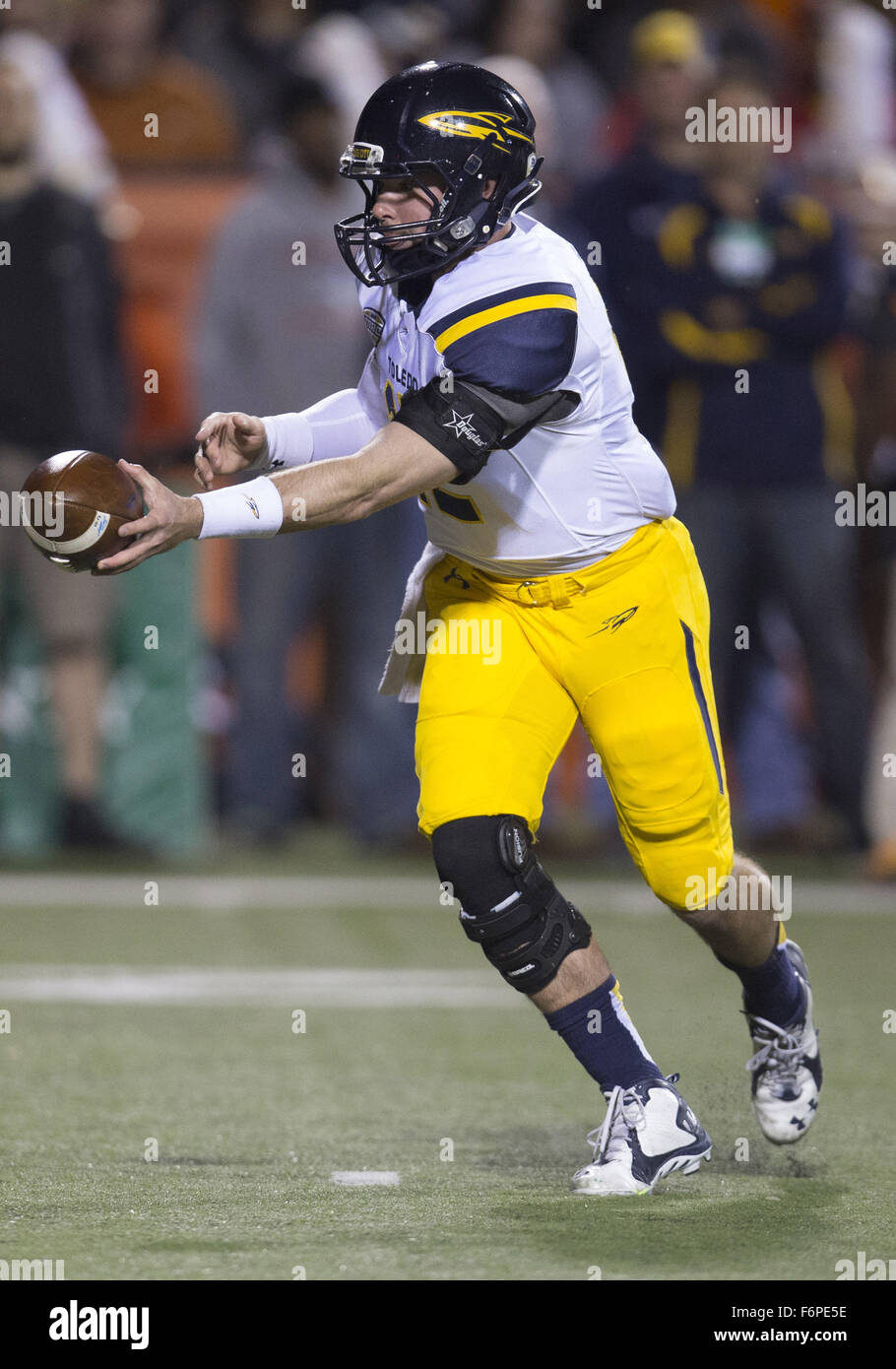 Bowling Green, Ohio, USA. 17th Nov, 2015. Toledo quarterback Phillip Ely (12) hands the ball off during NCAA football game action between the Toledo Rockets and the Bowling Green Falcons at Doyt L. Perry Stadium in Bowling Green, Ohio. Toledo defeated Bowling Green 44-28. John Mersits/CSM/Alamy Live News Stock Photo