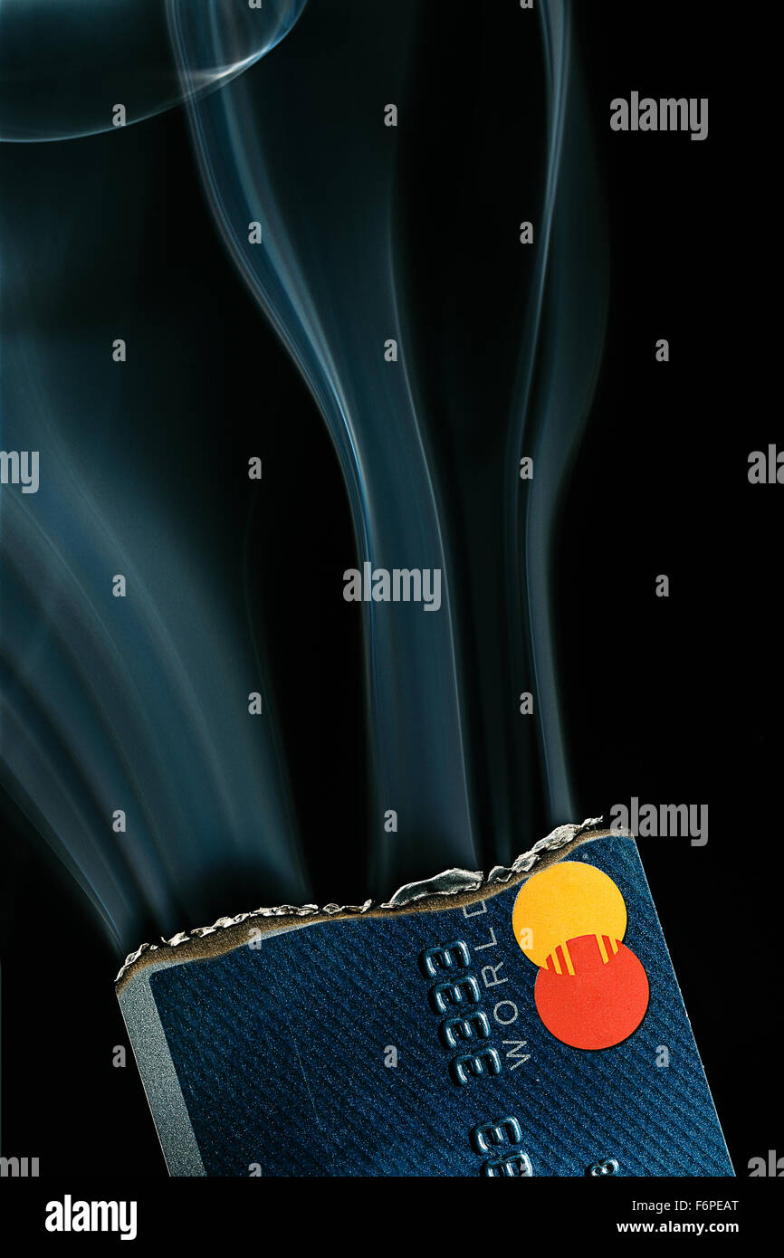 Credit card on fire. Heavy spending, burning through money, racking up