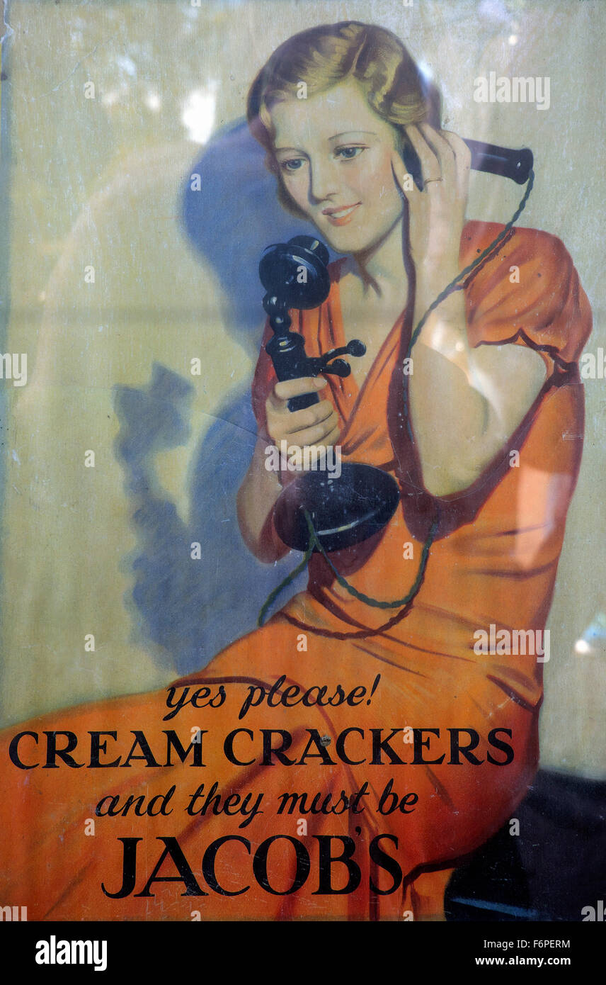 Vintage advertisement poster with woman talking on old telephone phone ordering Jacobs Cream Crackers in Great Britain  UK    KATHY DEWITT Stock Photo