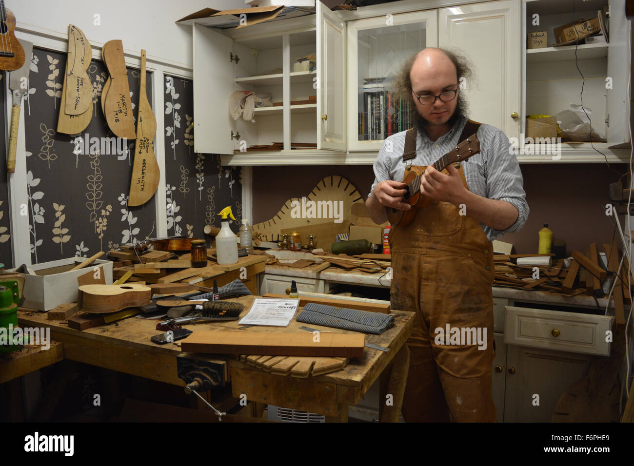 Luthier, Liam Kirby, in his ukulele and guitar workshop. Wunderkammer Musical Instrument Co. Bristol, England Stock Photo