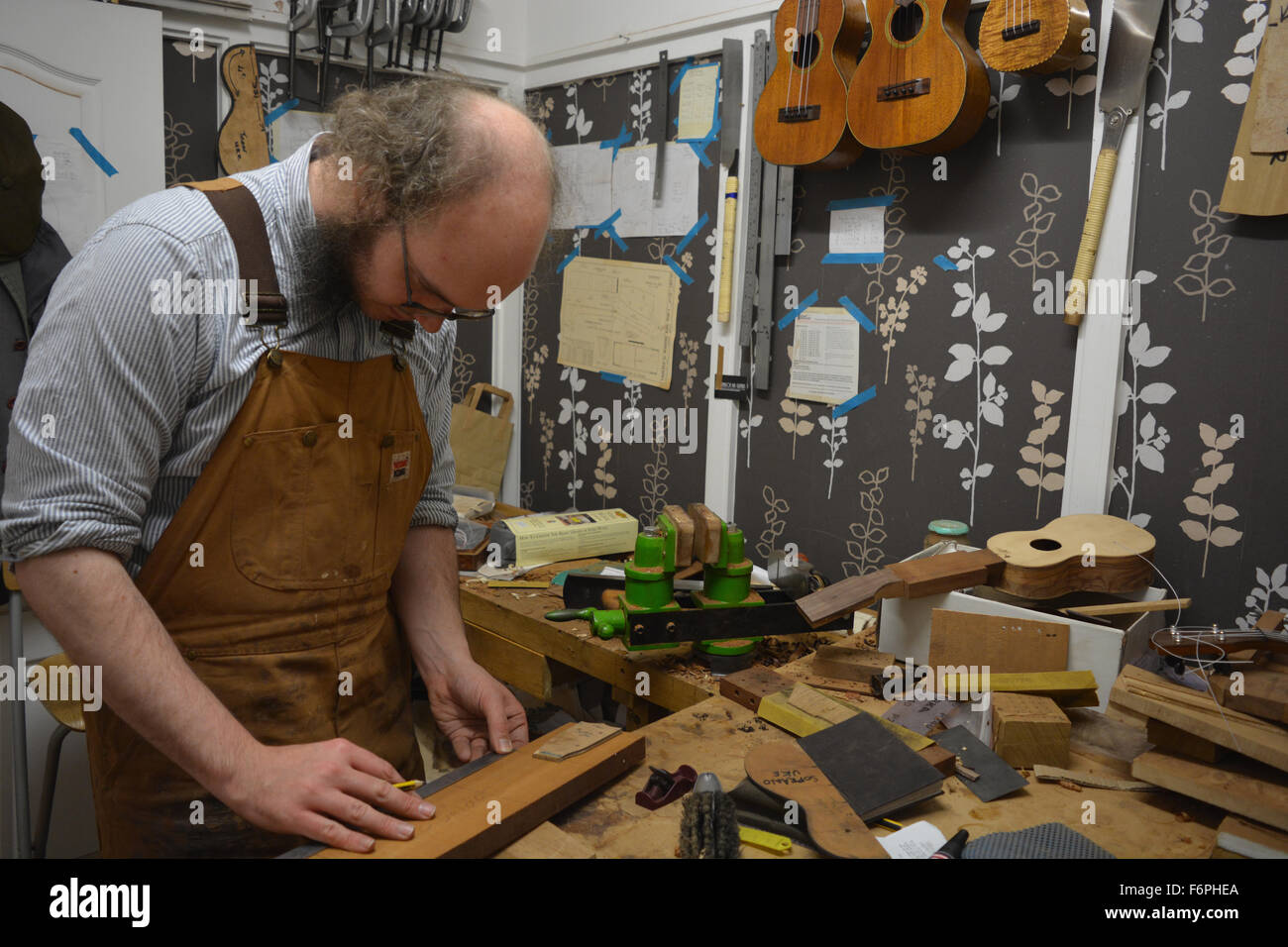 Luthier, Liam Kirby, in his ukulele and guitar workshop. Wunderkammer Musical Instrument Co. Bristol, England Stock Photo