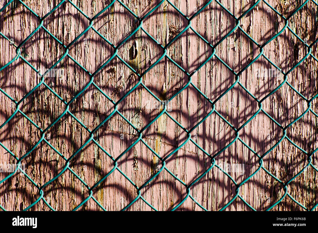 Graphic patterns created by wire mesh, hurricane, or cyclone steel fence Stock Photo