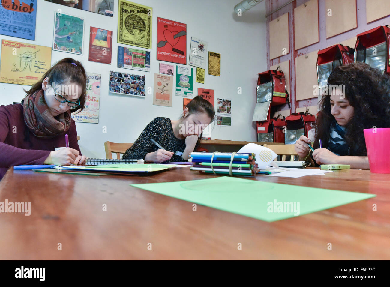 Volunteers writing recipes At NGO Meals on Wheels in Montreal Stock Photo