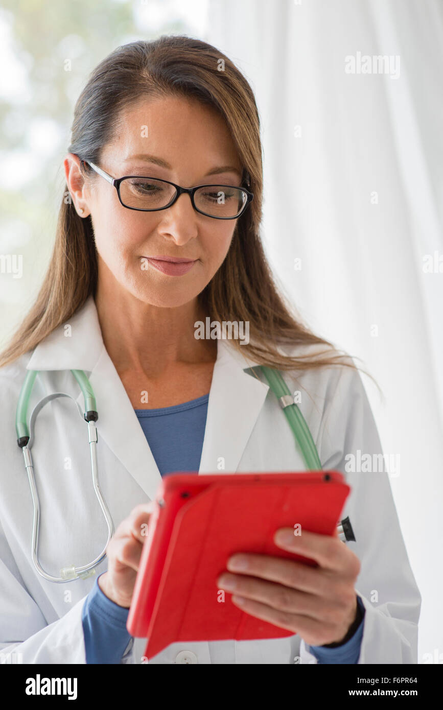 Female doctor using computer smiling hi-res stock photography and ...