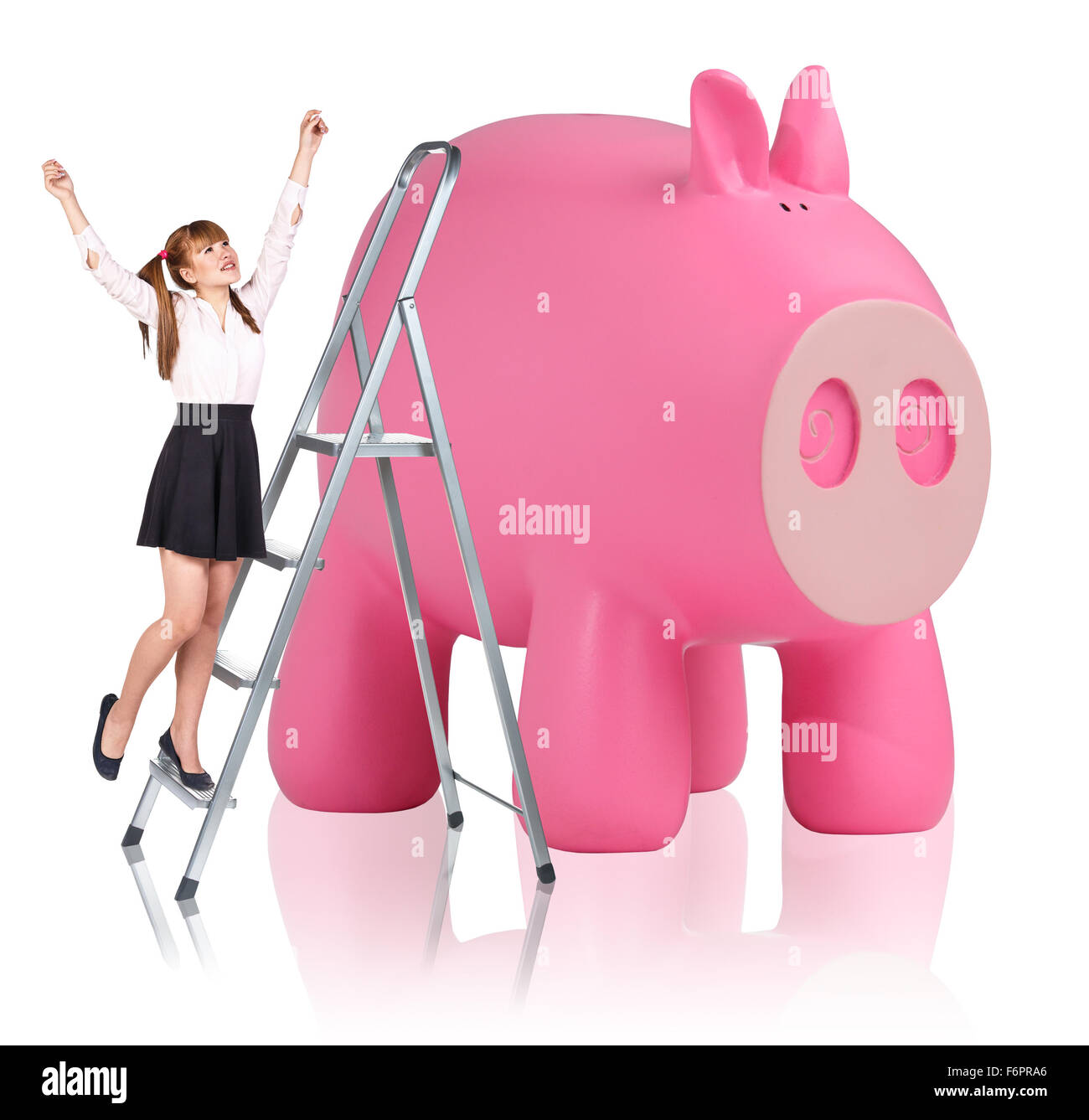 Woman rises up on the stepladder near piggy bank Stock Photo