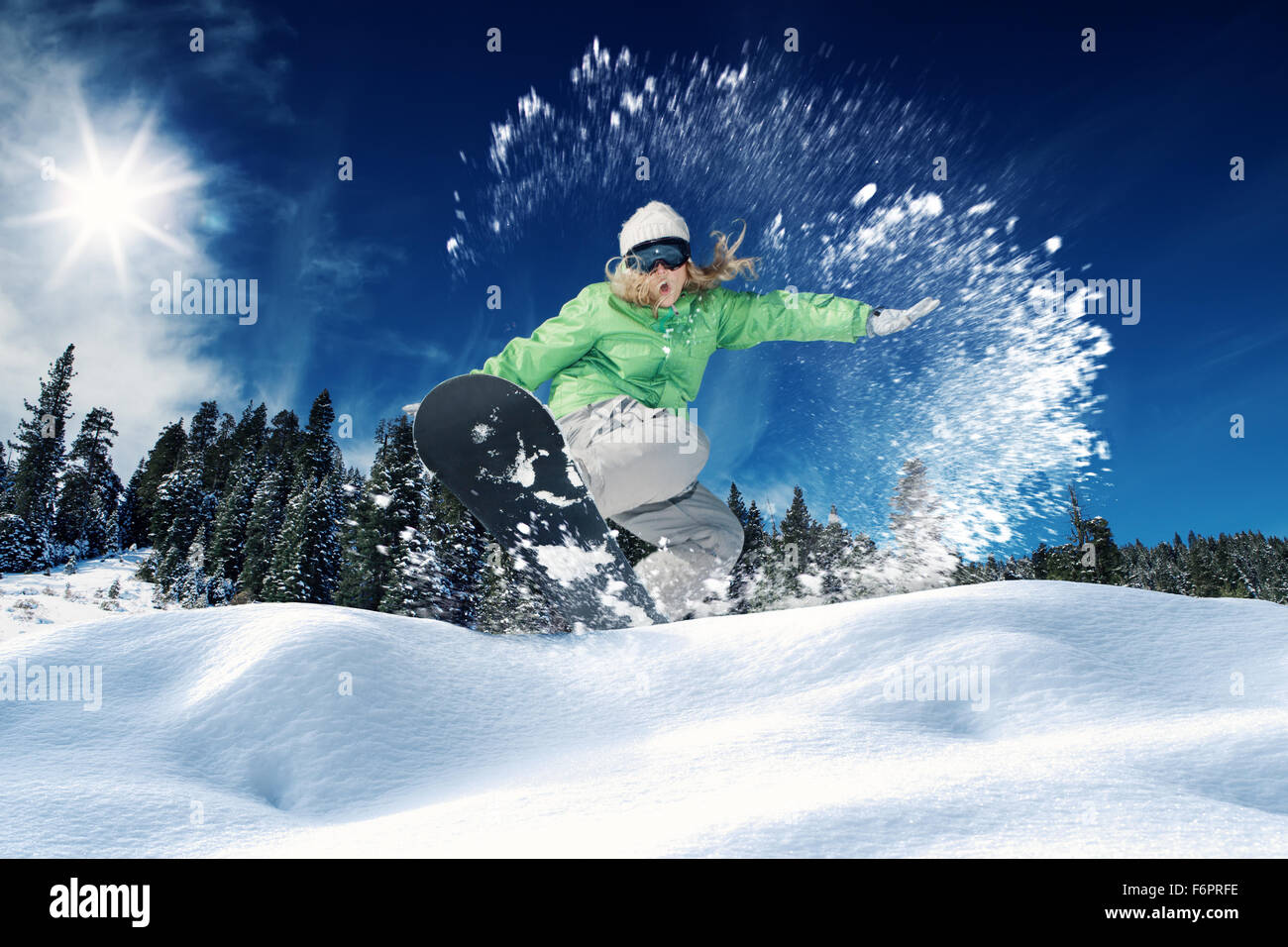 view of a young girl snowboarding in winter environment Stock Photo