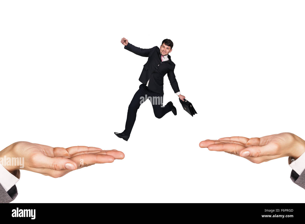 Businessman jumping on hands Stock Photo Alamy