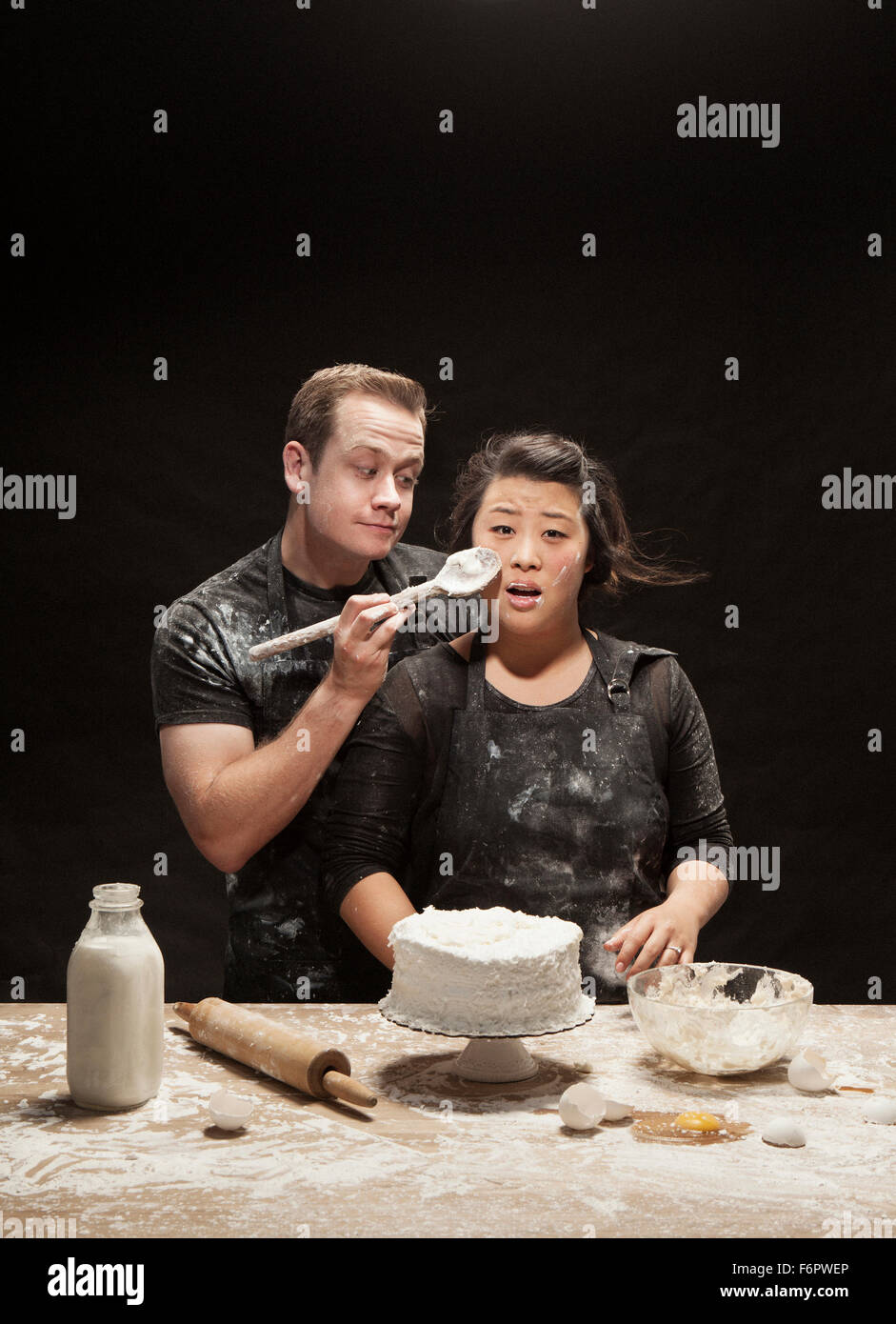 Messy couple baking cake Stock Photo