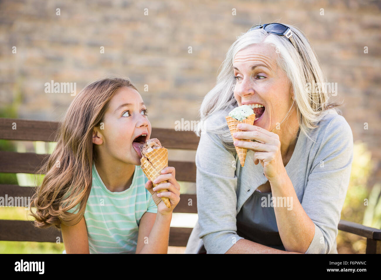 Caucasian grandmother and granddaughter eating ice cream Stock Photo