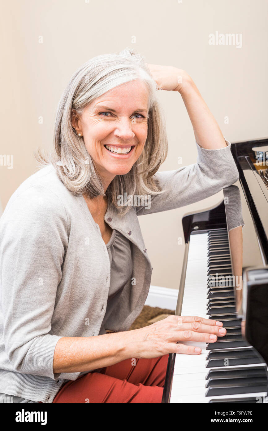 Caucasian woman playing piano Stock Photo