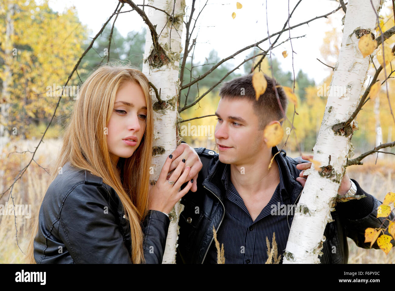 boy and girl at a birch in autumn Stock Photo