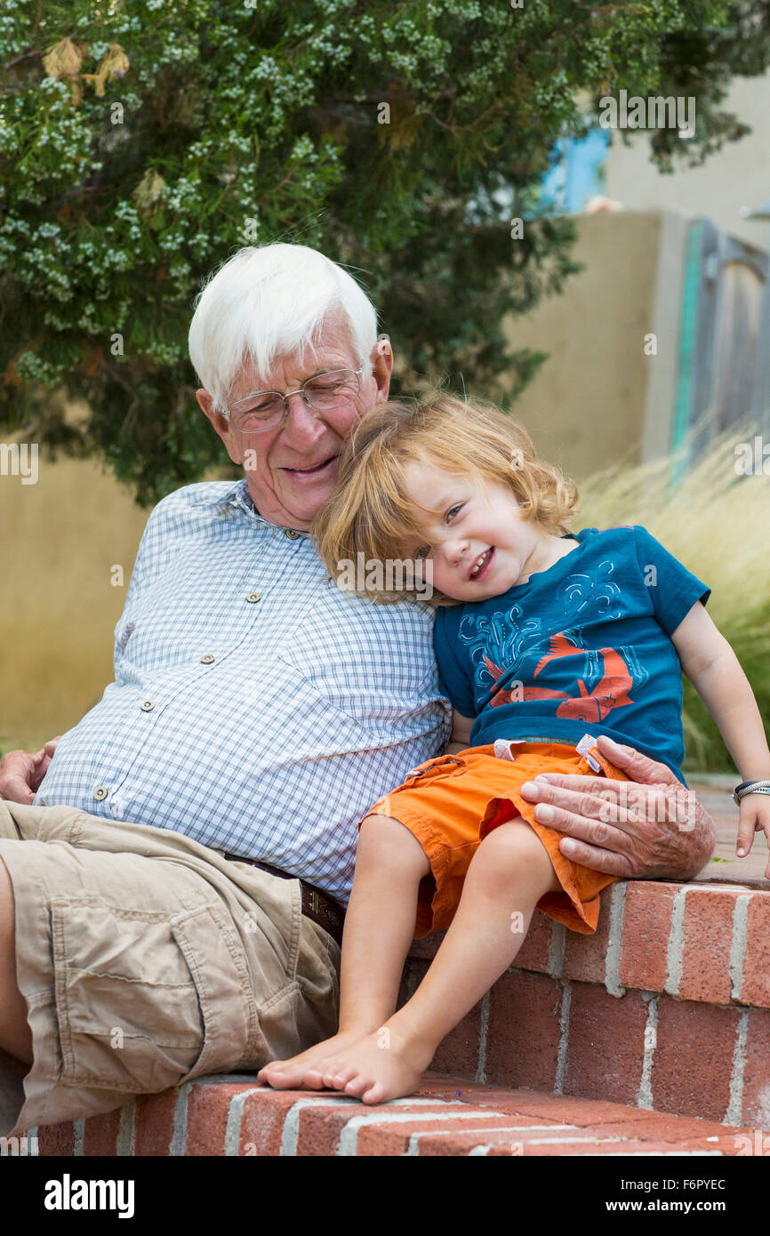 Caucasian grandfather and grandson hugging outdoors Stock Photo