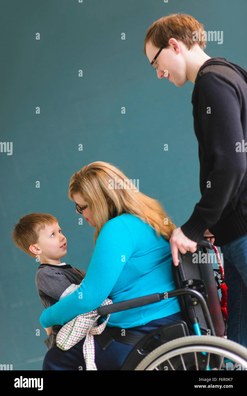 Man pushing paraplegic wife and son Stock Photo