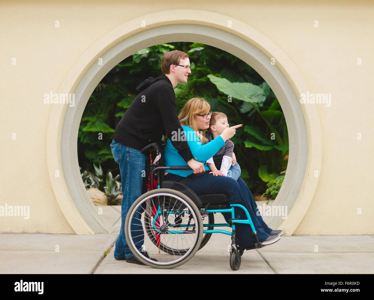 Man pushing paraplegic wife and son Stock Photo