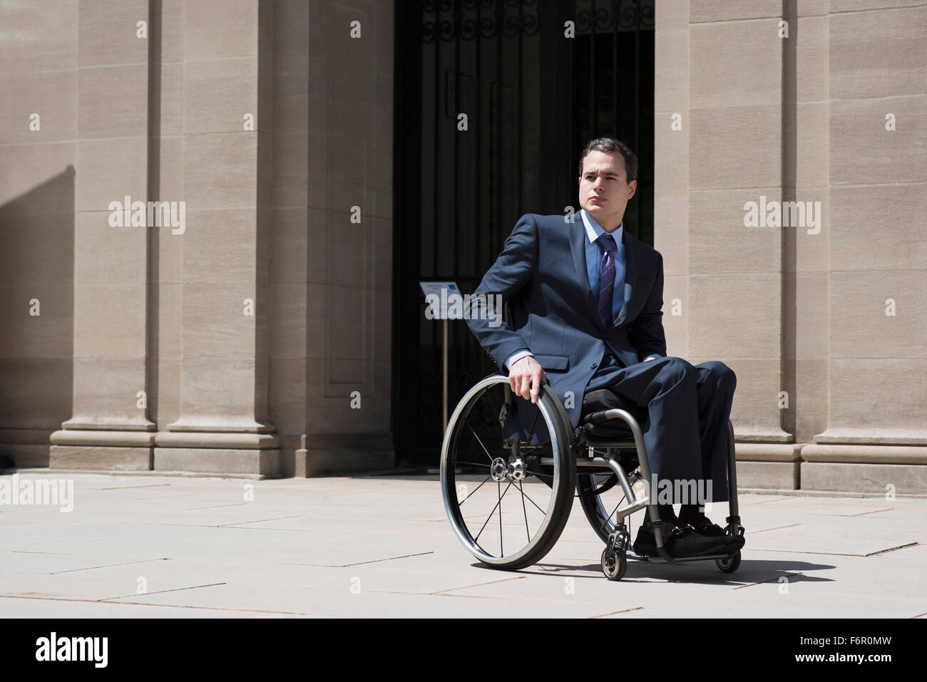 Paraplegic businessman sitting in wheelchair Stock Photo