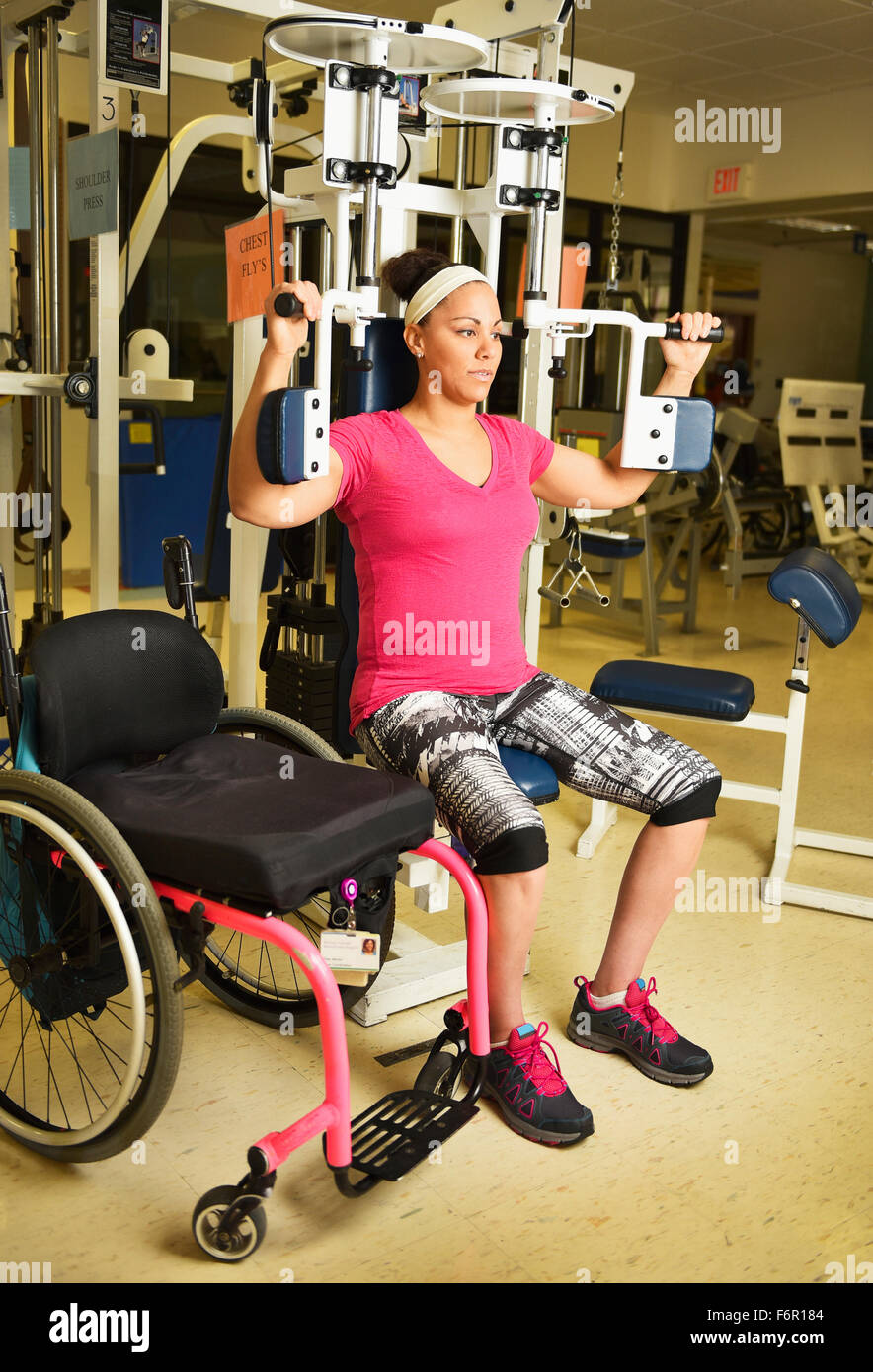 Paraplegic woman working out in physical therapy Stock Photo