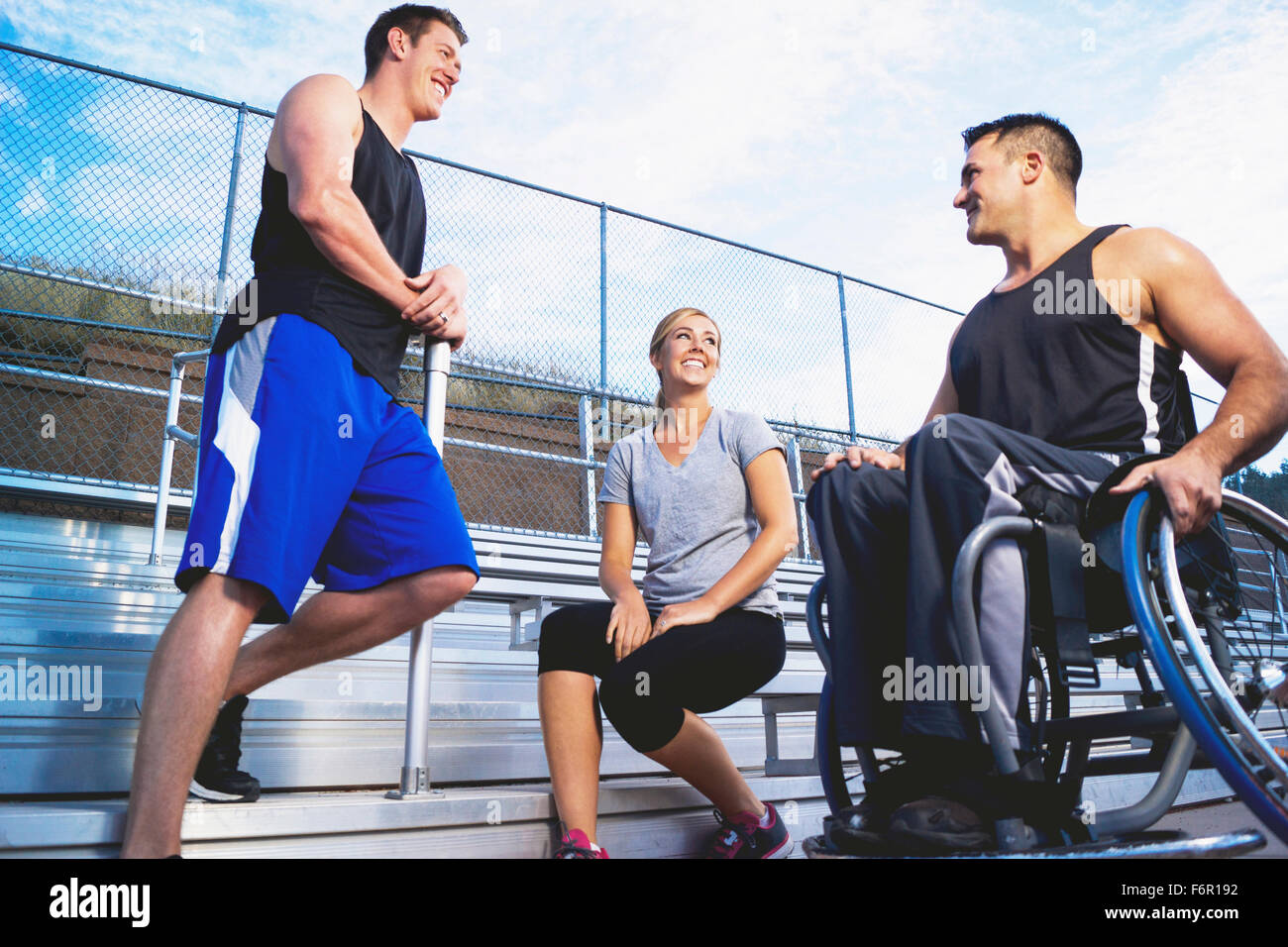 https://c8.alamy.com/comp/F6R192/paraplegic-athlete-in-wheelchair-with-friends-on-bleachers-F6R192.jpg