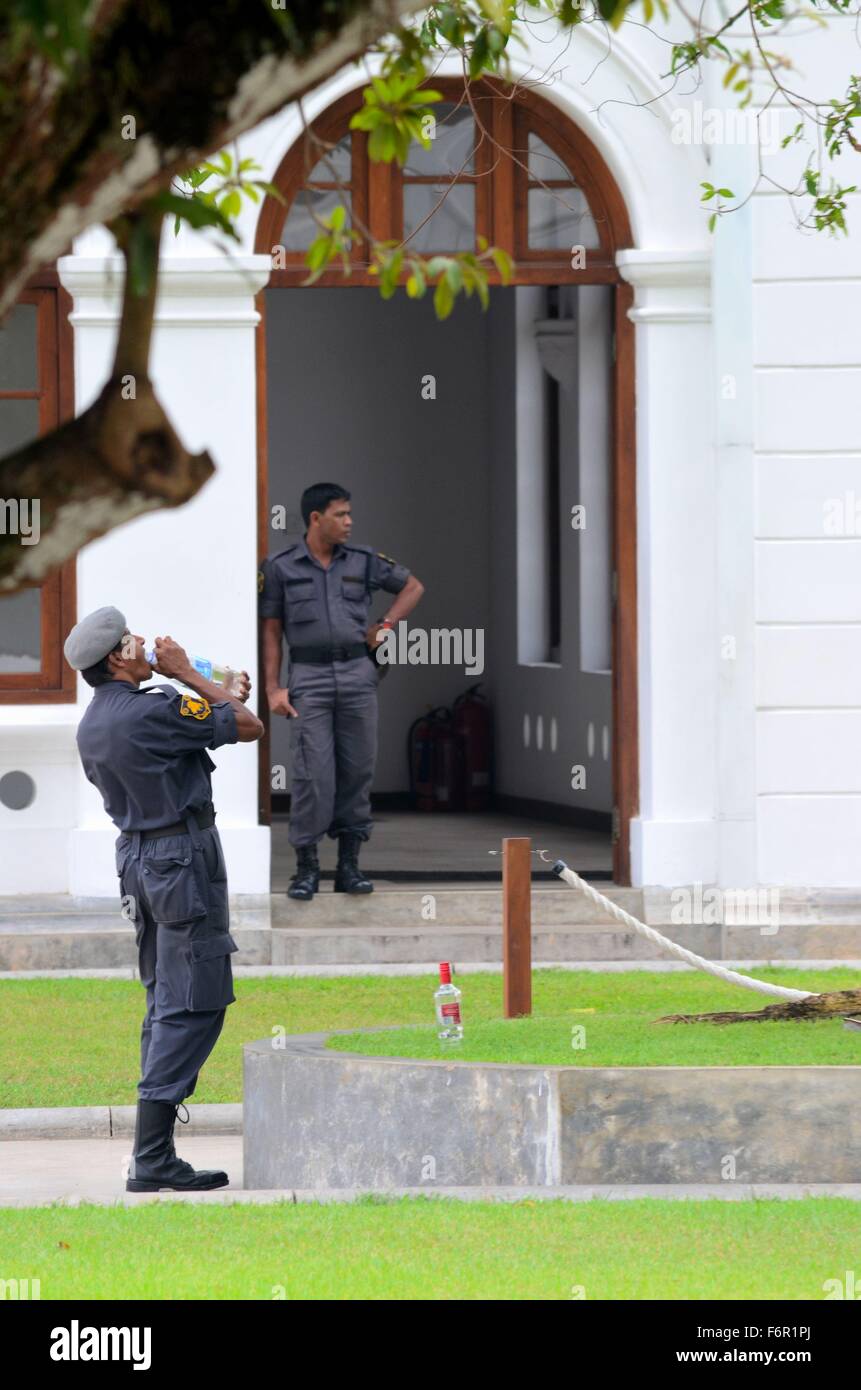 Police officers guard and drink water at Arcade Independence Square Colombo Sri Lanka Stock Photo