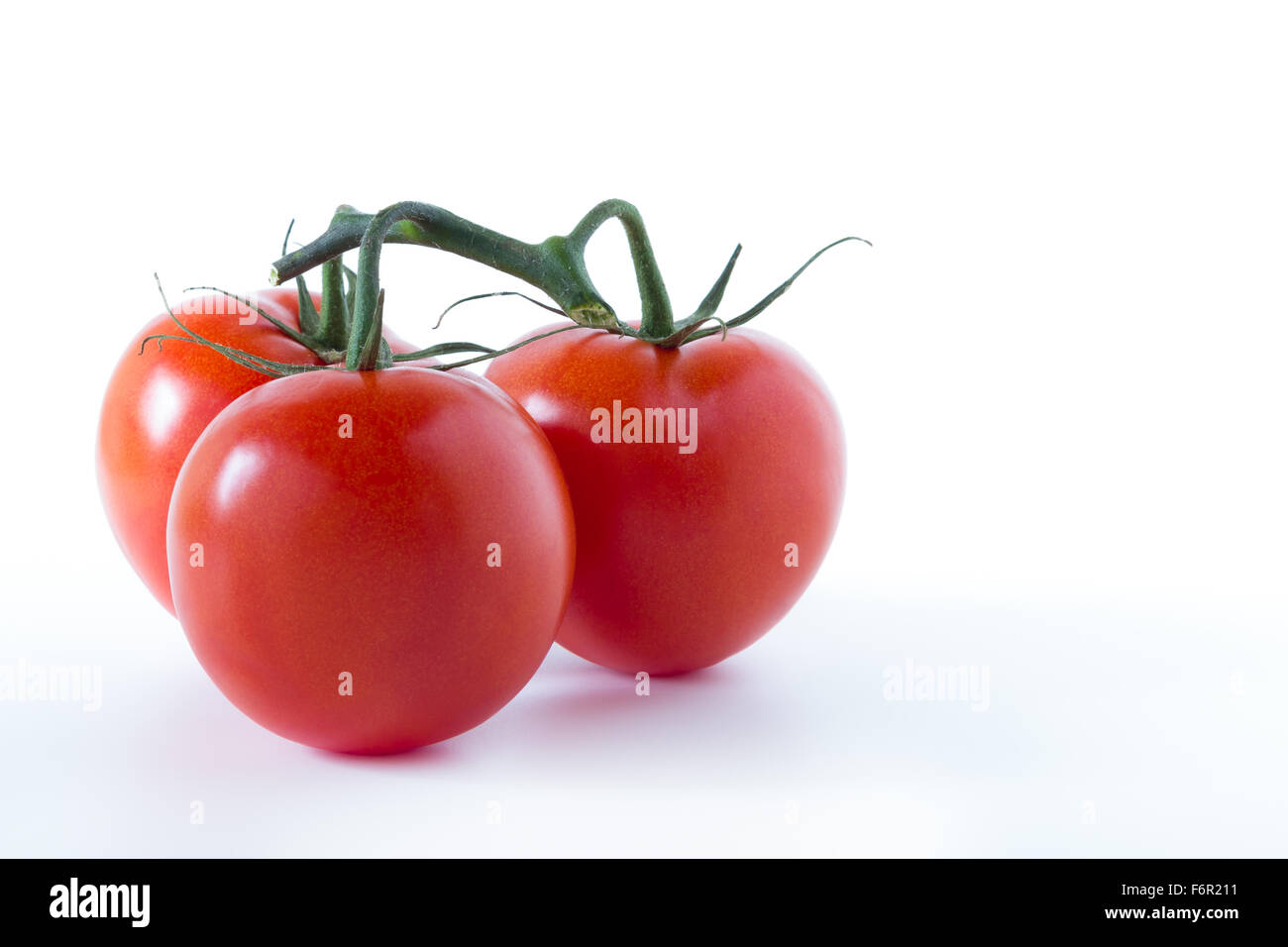 Three ripe tomatoes, isolated on white background Stock Photo - Alamy
