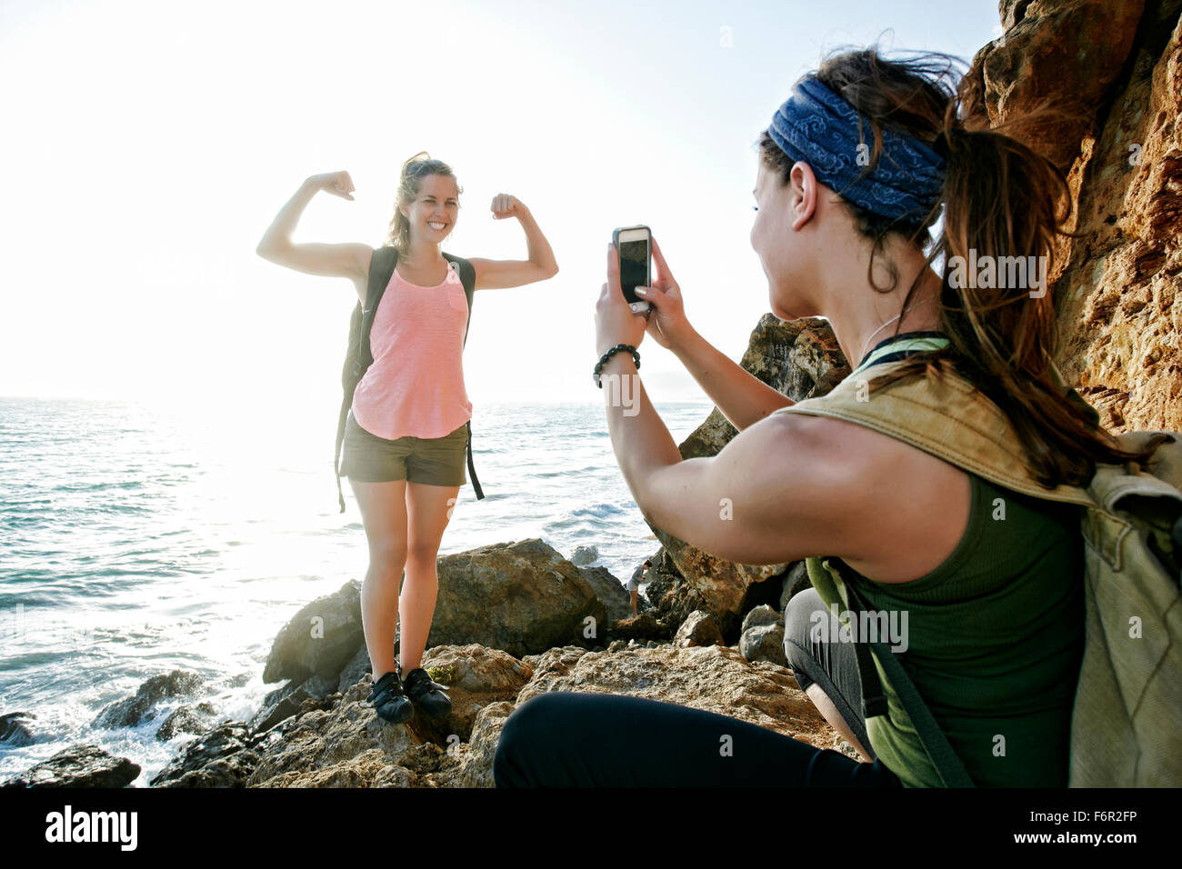 Woman photographing friend outdoors Stock Photo