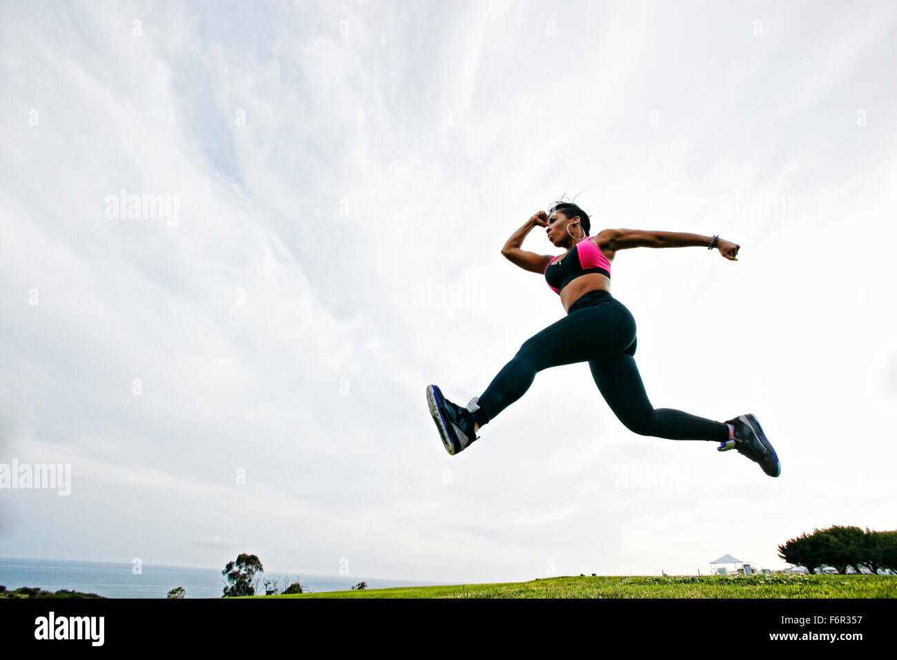 Black woman working out in field Stock Photo