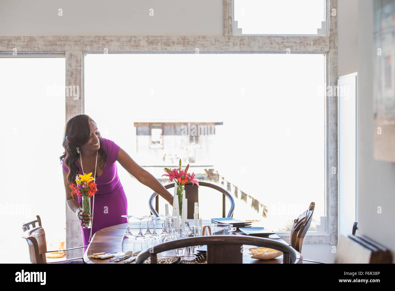 Woman setting dining table Stock Photo