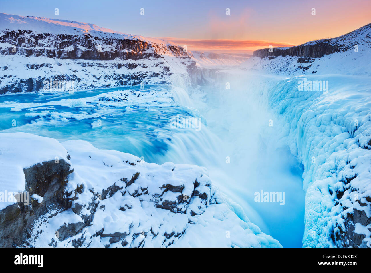 The Gullfoss Falls in Iceland in winter when the falls are partially frozen. Photographed at sunset. Stock Photo