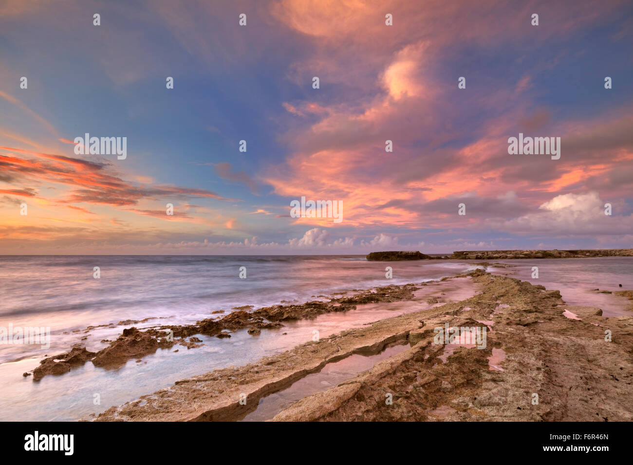 A rocky tropical coast at sunset. Photographed at Playa Canoa on Curaçao, The Netherlands Antilles. Stock Photo