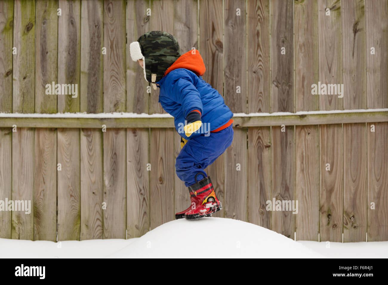 Caucasian boy playing in snow Stock Photo