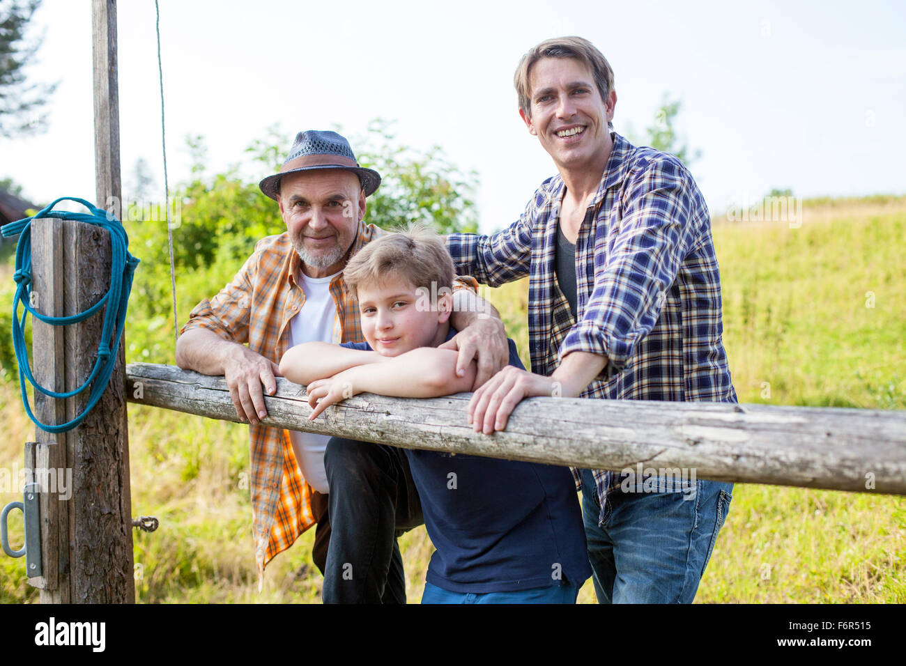 Portrait of multi-generation family by fence Stock Photo