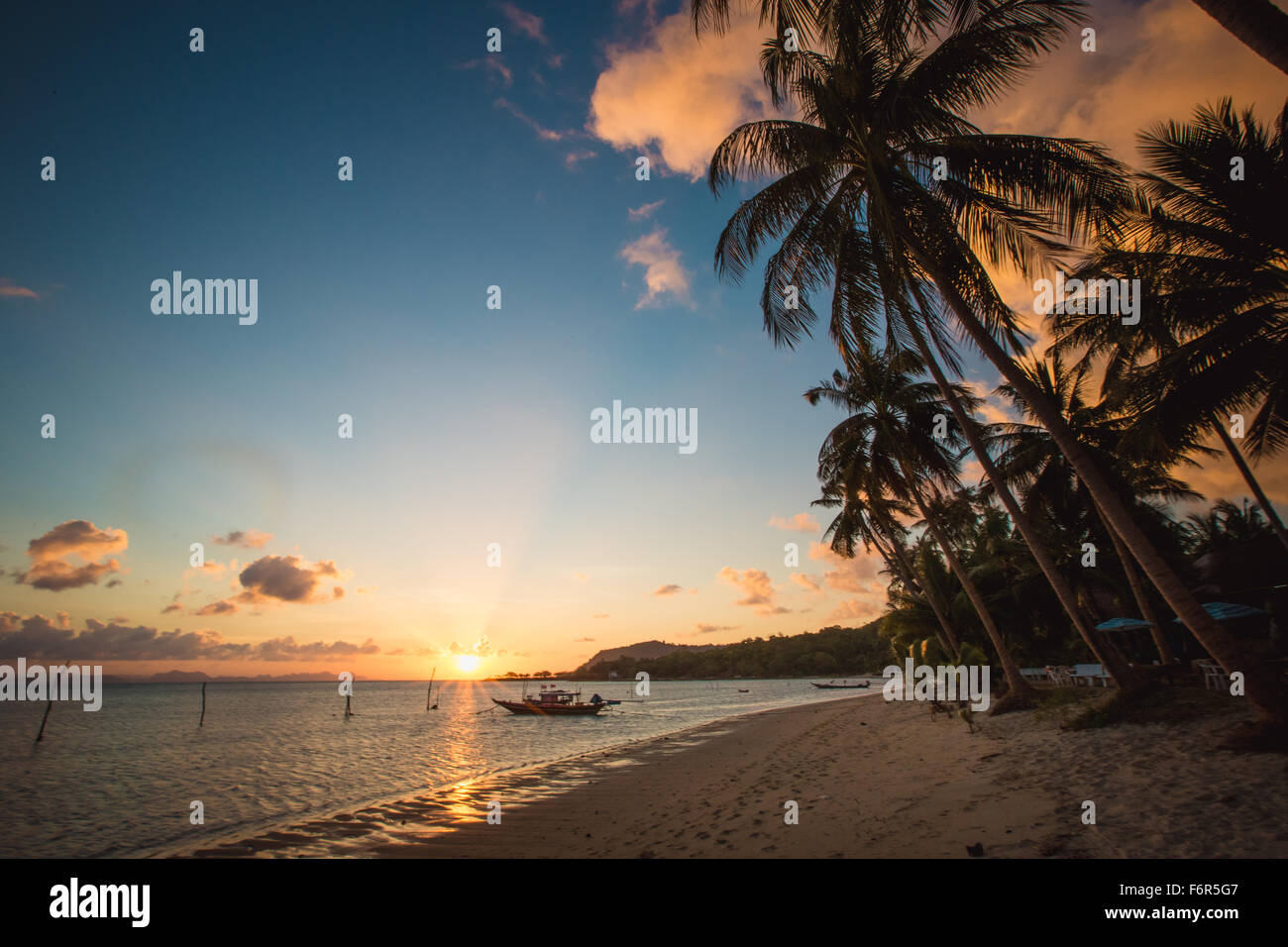 Sunset over the tropical beach Stock Photo - Alamy