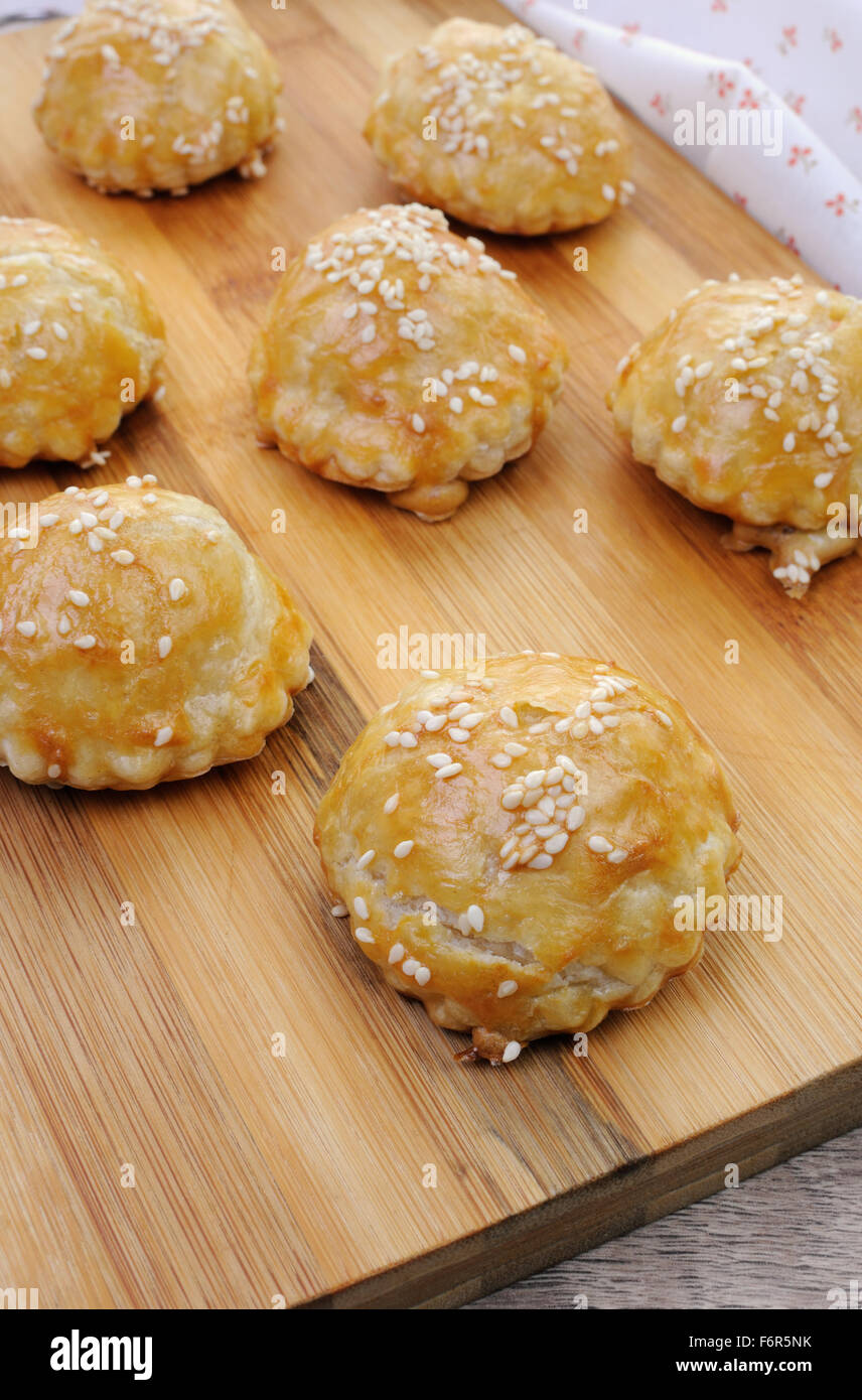 Bun puff pastry with sesame seeds on a wooden board Stock Photo