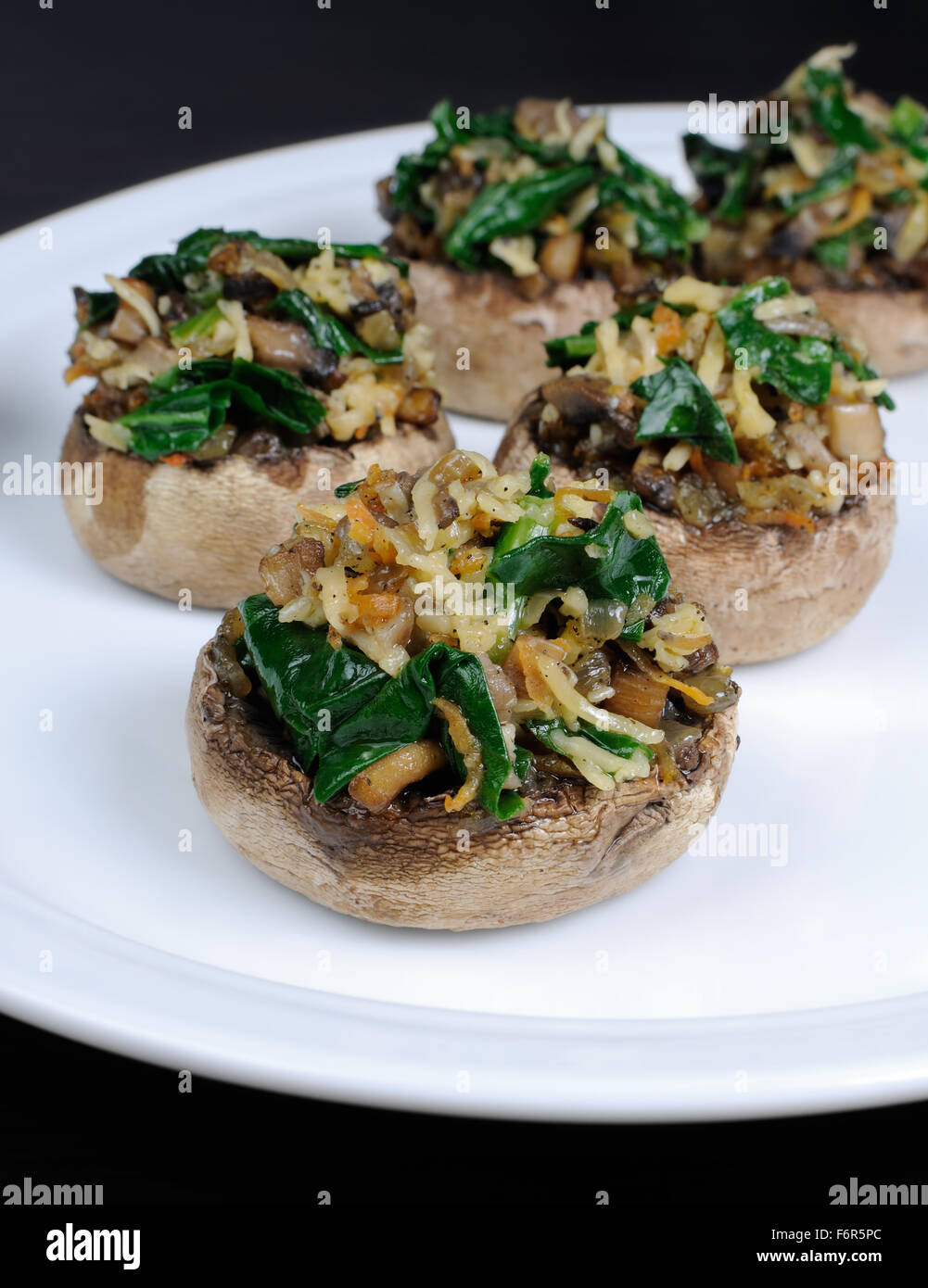 champignons  with vegetable stuffing  spinach and parmesan Stock Photo