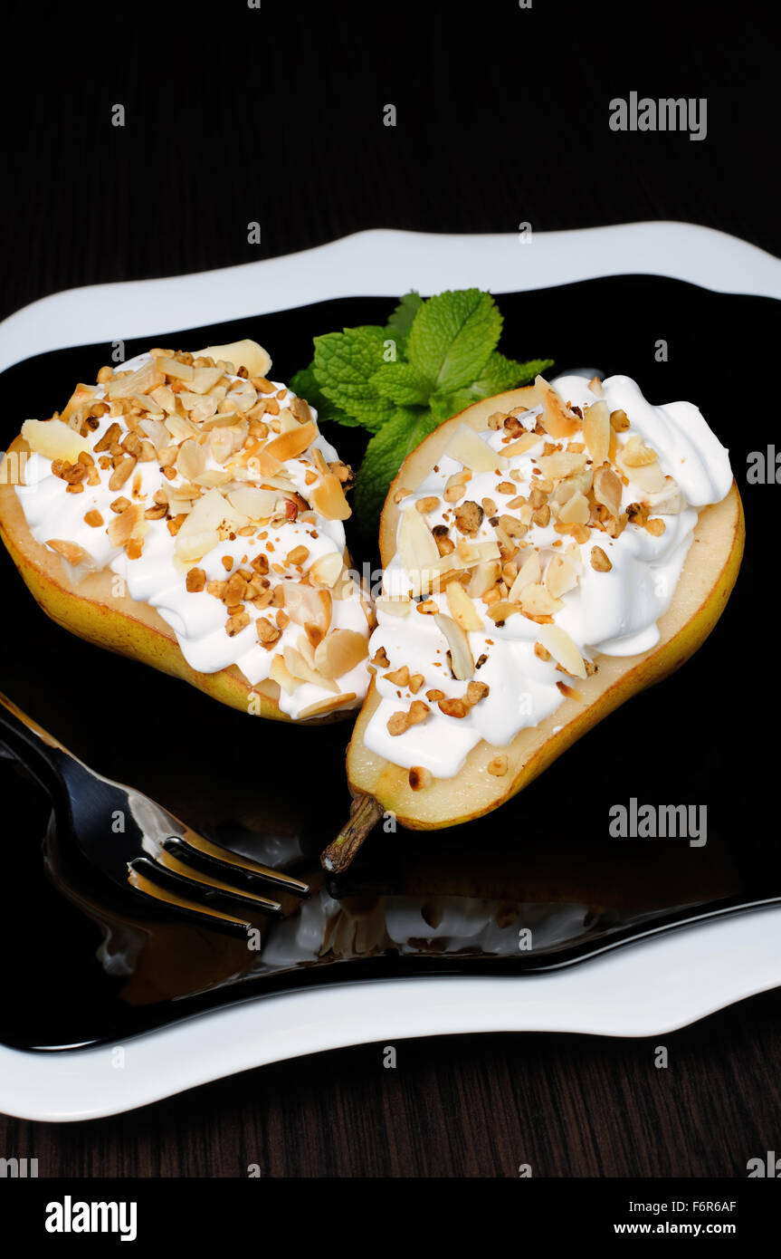 pears with whipped cream sprinkled   nuts and almonds Stock Photo