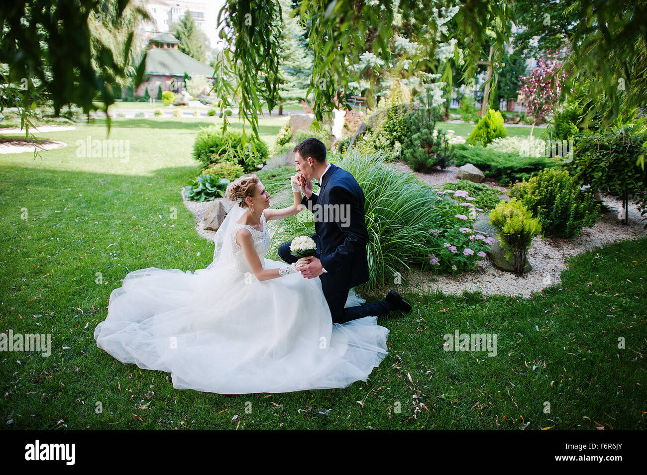 exciting elegant wedding couple walking at park in love Stock Photo - Alamy