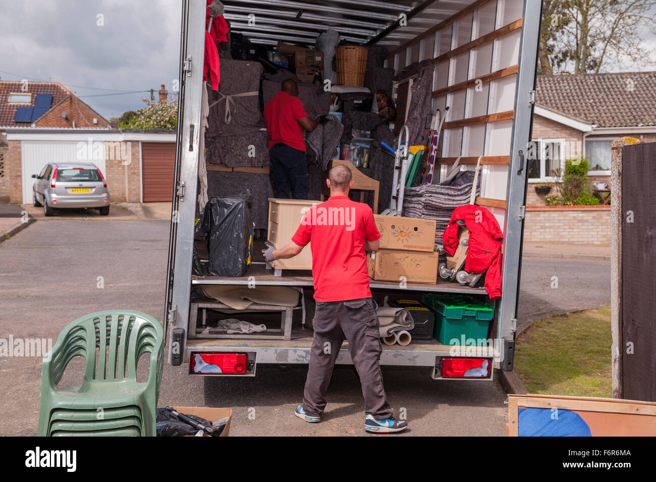 Removal men packing a removal van helping family move house in the Uk