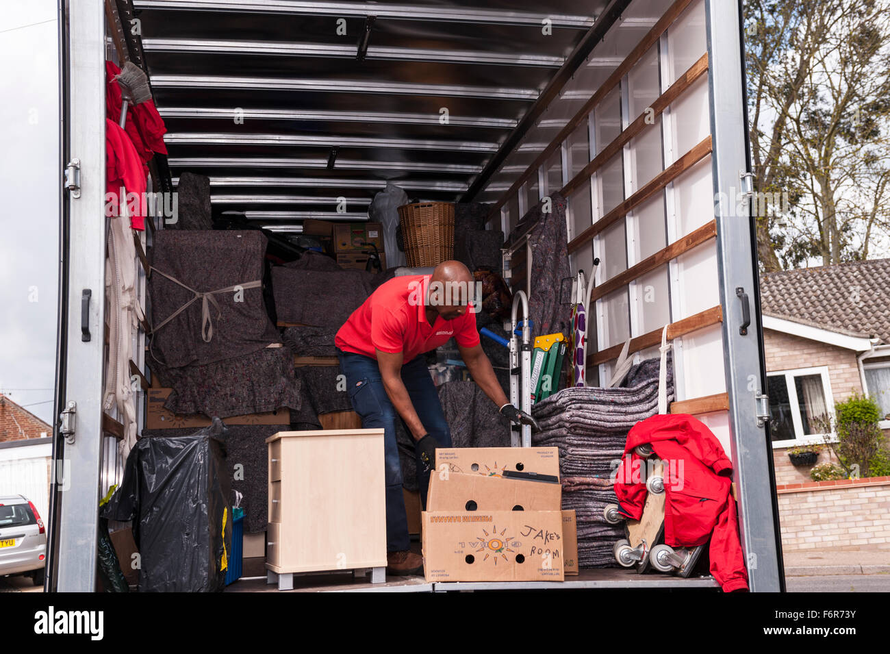 Removal men packing a removal van helping family move house in the Uk Stock Photo Alamy
