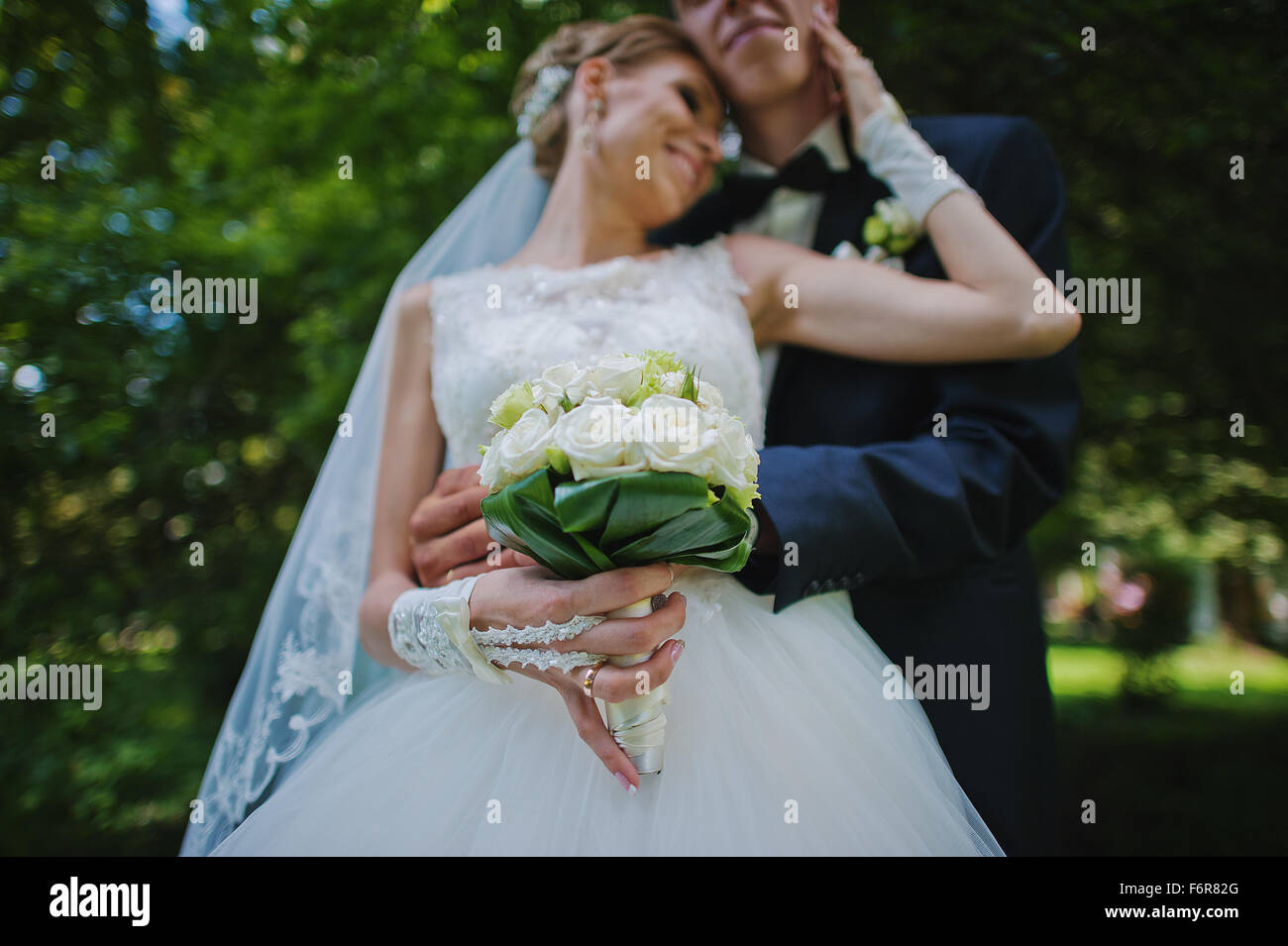 exciting elegant wedding couple walking at park in love Stock Photo - Alamy