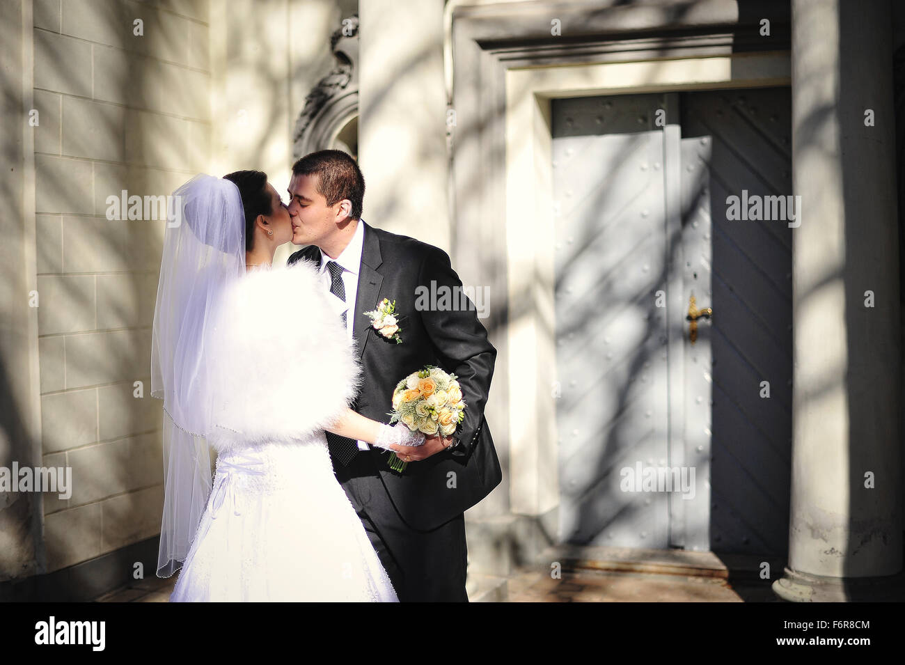 Gorgeous married couple kissing background old columns with shadow ...