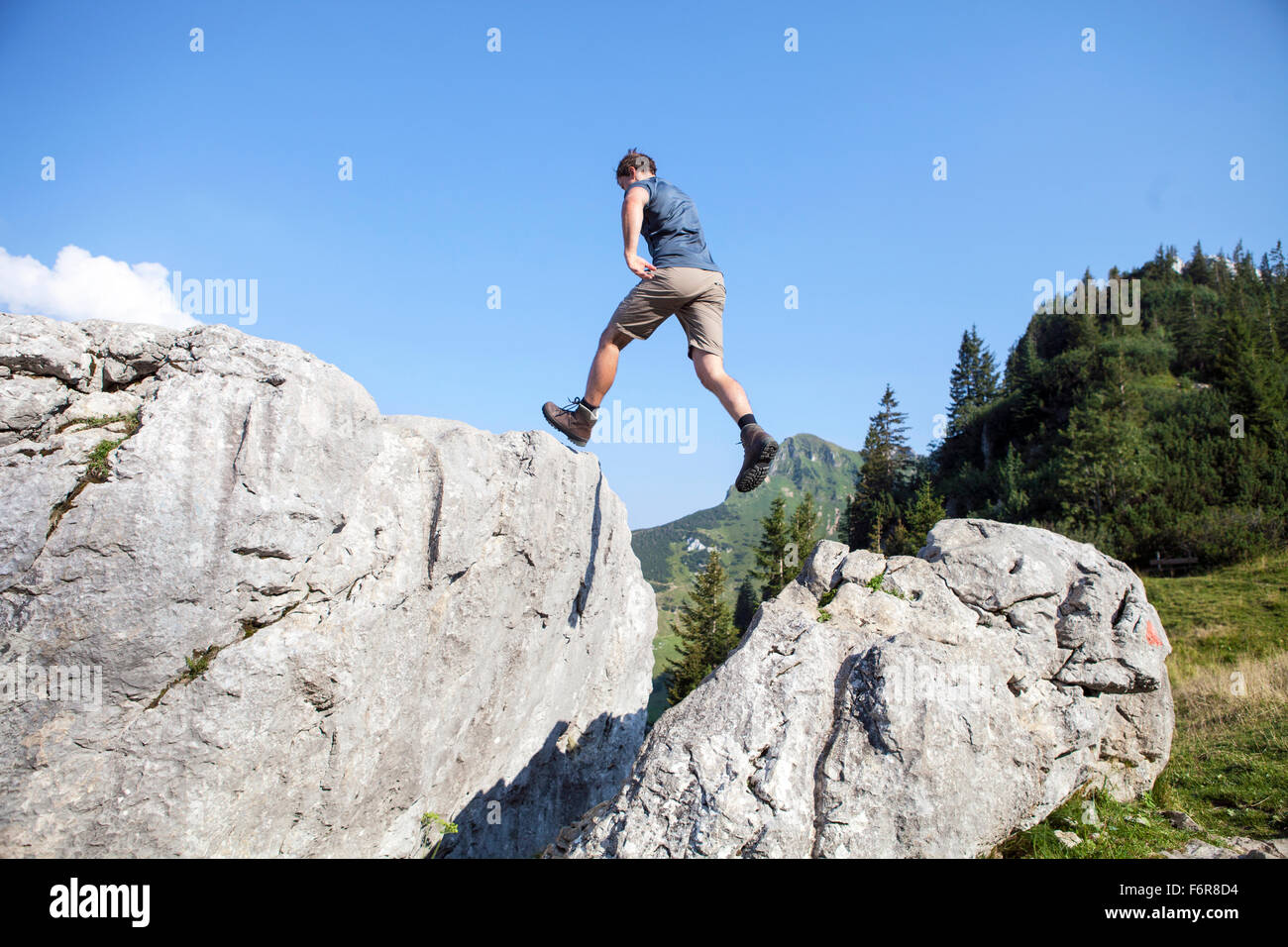 Young man hiking in mountain landscape Stock Photo
