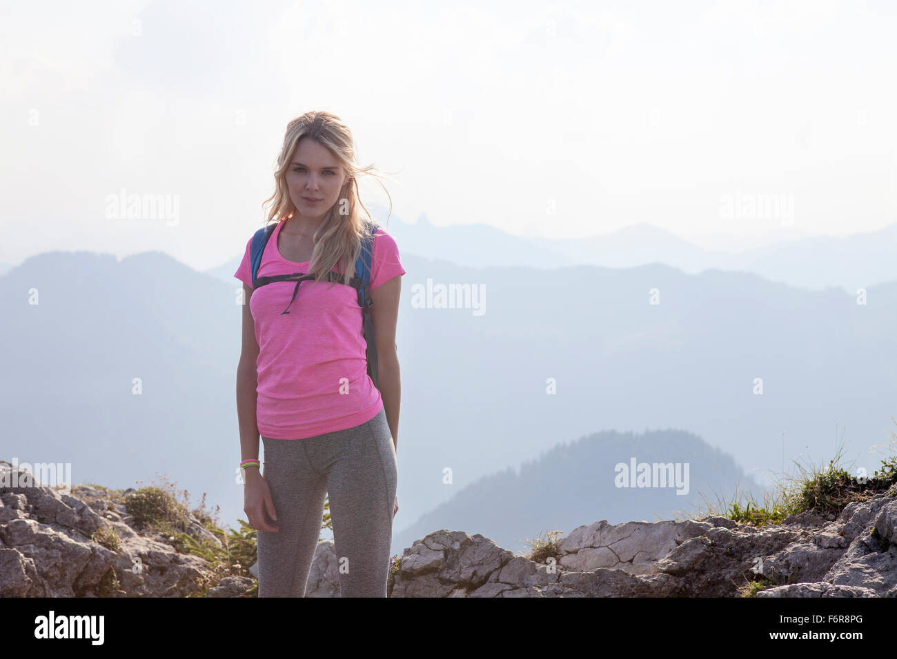 Young woman hiking in mountain landscape Stock Photo - Alamy