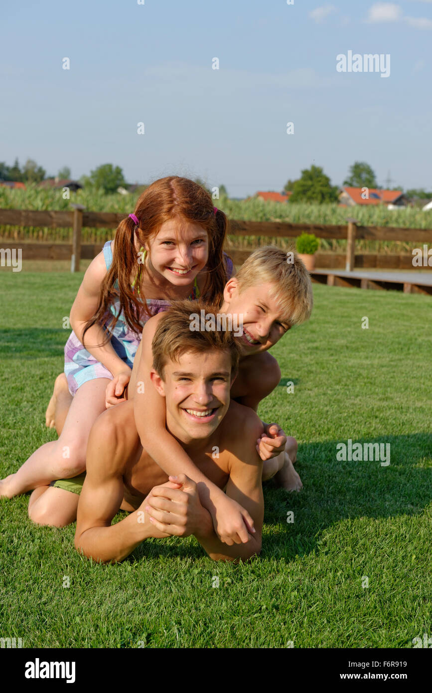 Girls and boys, kids, teens, siblings in the garden, having fun, Upper Bavaria, Bavaria, Germany Stock Photo