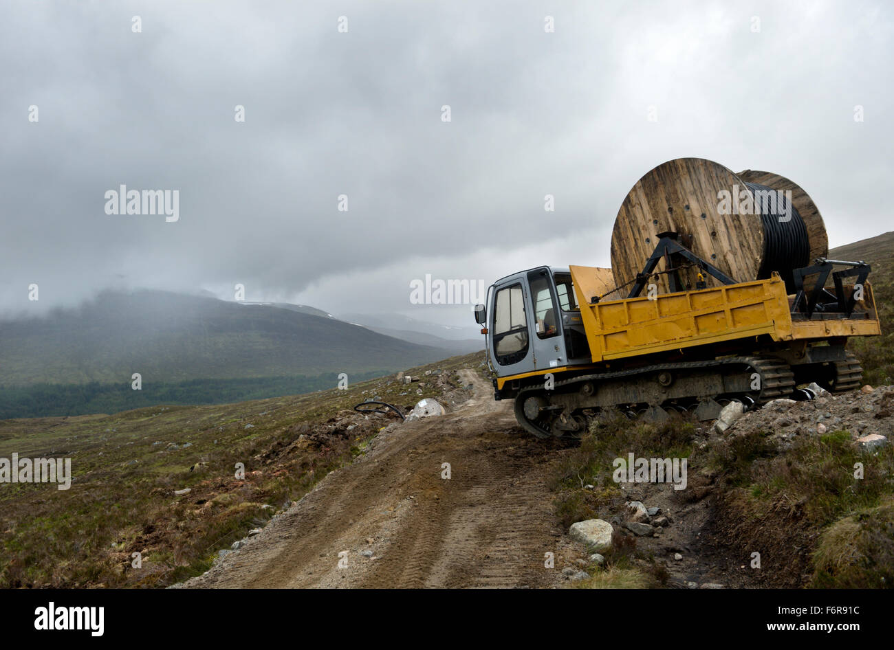 Installation of power supply cables over remote scottish hills Stock Photo