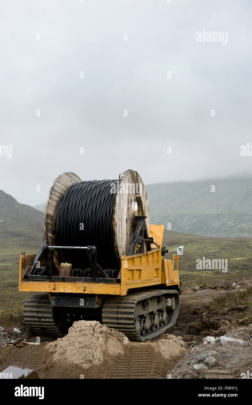 Installation of power supply cables over remote scottish hills Stock Photo