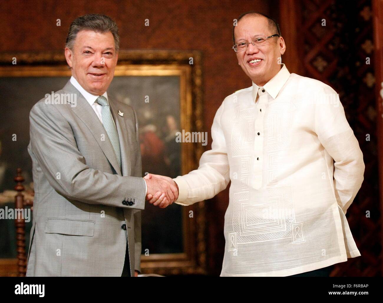 Philippine President Benigno Aquino III welcomes Colombia President Juan Manuel Santos, left, before their bilateral meeting on the sidelines of the APEC Leaders Summit at the Malacanang Palace November 17, 2015 in Manila, Philippines. Stock Photo