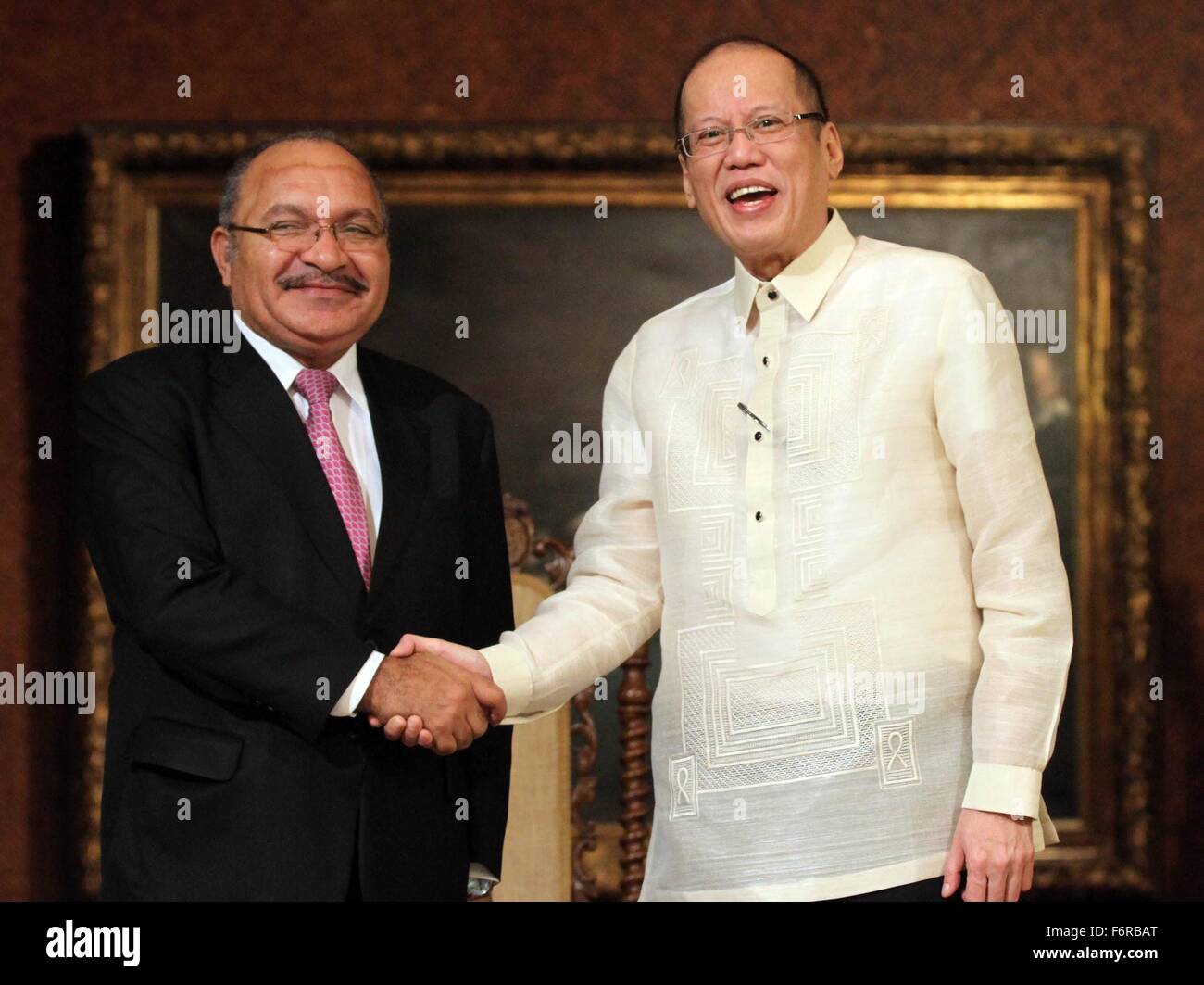 Philippine President Benigno Aquino III welcomes Papua New Guinea Prime Minister Peter O'Neill, left, before their bilateral meeting on the sidelines of the APEC Leaders Summit at the Malacanang Palace November 17, 2015 in Manila, Philippines. Stock Photo