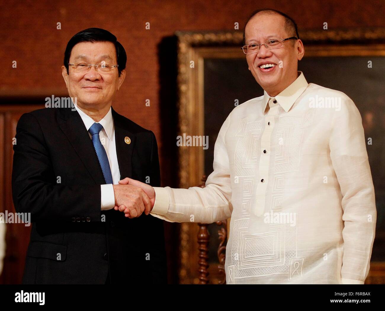 Philippine President Benigno Aquino III welcomes Vietnam President Truong Tan Sang, left, before their bilateral meeting on the sidelines of the APEC Leaders Summit at the Malacanang Palace November 17, 2015 in Manila, Philippines. Stock Photo