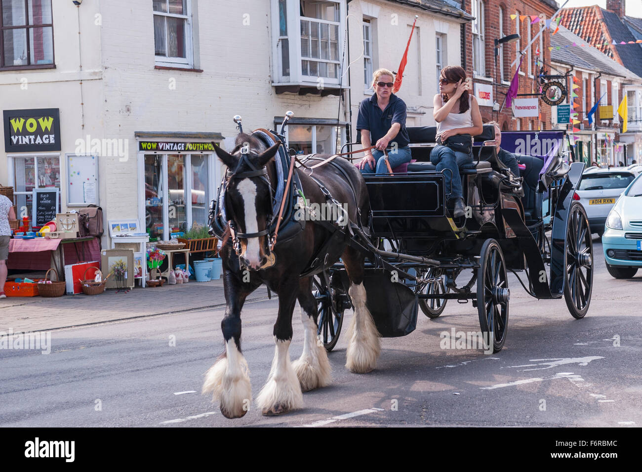 A horse and carriage ride in the High Street  in Southwold , Suffolk , England , Britain , Uk Stock Photo